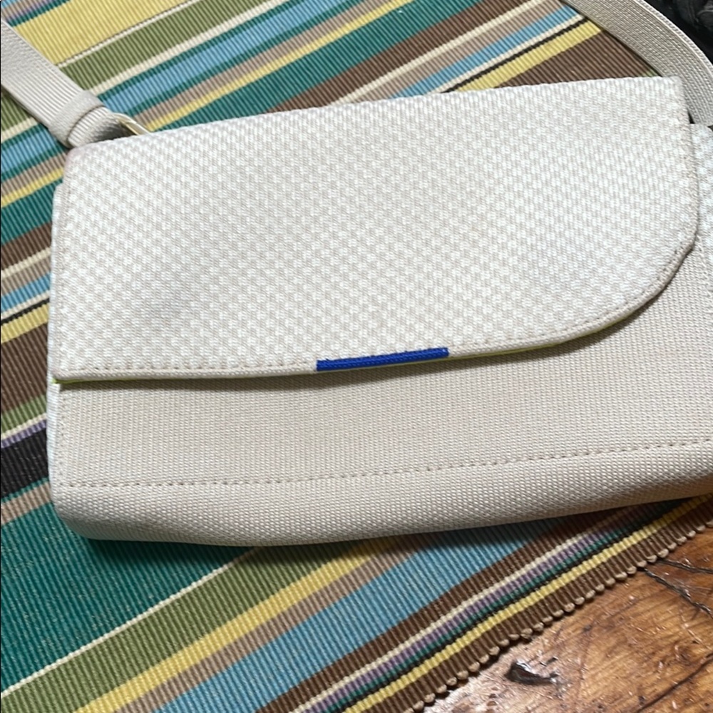 Rothy’s Cream Textured Crossbody Clutch with Blue Accent
